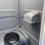 flushing toilet inside deluxe portable toilet