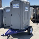 front view of portable toilet trailer in yard